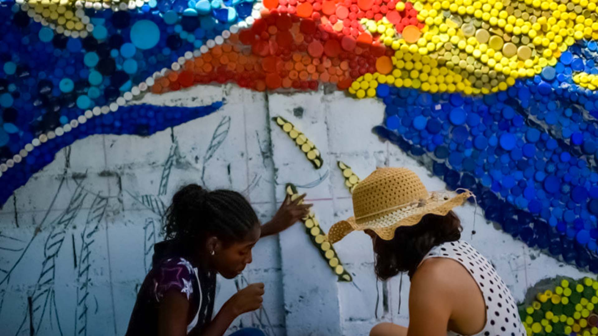 Caracas suburb is lit up by a Venezuelan mural artist using recycled plastic